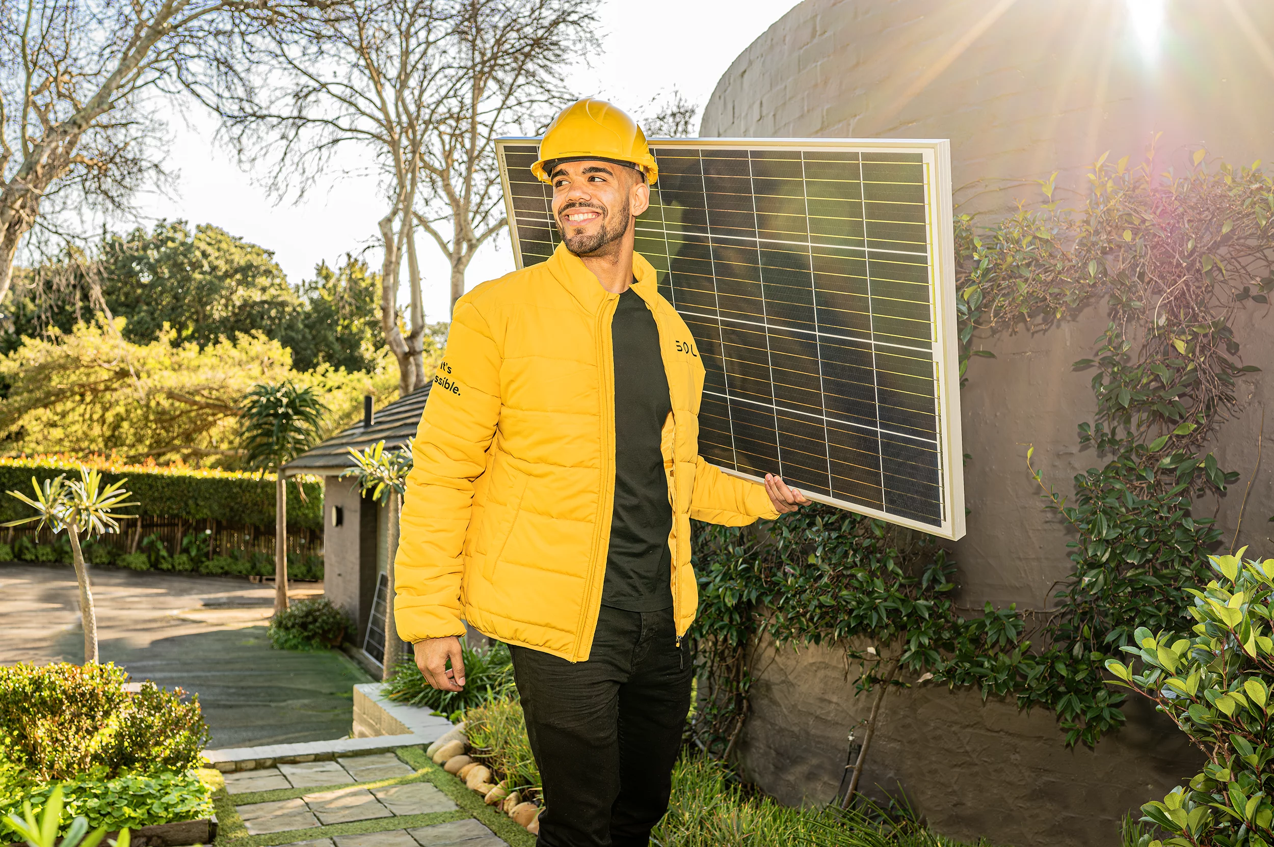 a soly installer holding a solar panel