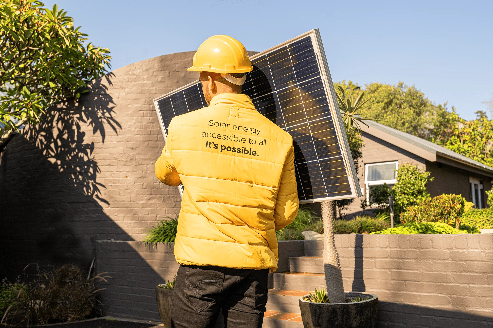 Soly installer carrying a solar panel