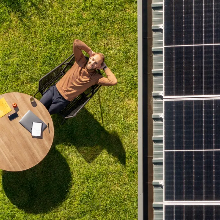 An owner that is happy and a roof fitted with solar panels